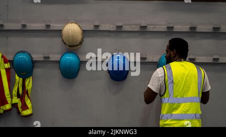 African American holding Safety Helmet , Safety helmet equipment in Manufacturing Factory site Stock Photo