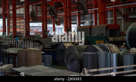 Rolls of galvanized steel sheet Scrap material stainless rolls Aluminium rolls inside the factory or warehouse. Stock Photo