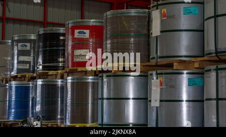 Rolls of galvanized steel sheet Scrap material stainless rolls Aluminium rolls inside the factory or warehouse. Stock Photo