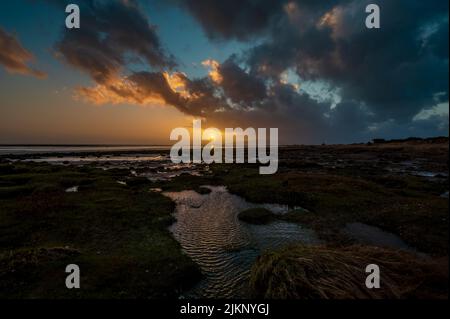 The cloudy sky over the sea captured at sunset in the evening Stock Photo