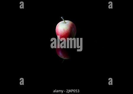 A closeup shot of a red apple isolated on the black background Stock Photo