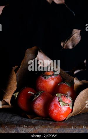A vertical shot of red tomatoes isolated on the black background Stock Photo
