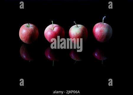 A closeup shot of red apples on the black background Stock Photo