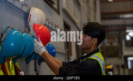 African American holding Safety Helmet , Safety helmet equipment in Manufacturing Factory site Stock Photo