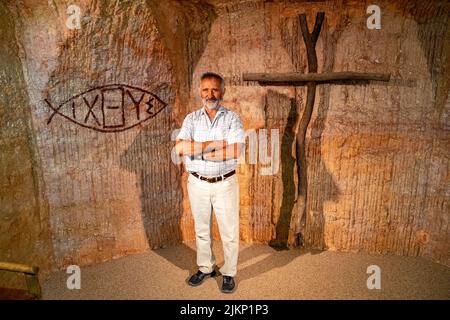 An Anglican priest in the underground Catacomb Church in the opal mining town of Coober Pedy, South Australia Stock Photo