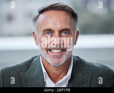 Before you are a leader, success is about growing yourself. Portrait of a confident mature businessman in an office. Stock Photo