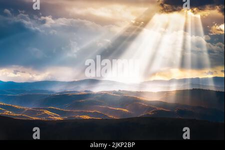 A scenic view of hills and mountains filled with evening sunrays Stock Photo