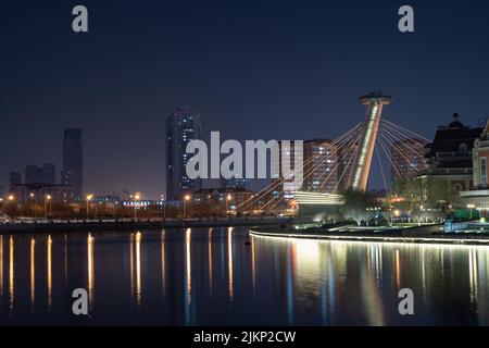 The famous bridge in Tianjin city at night along the Haihe River, China Stock Photo