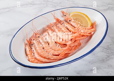 A close-up of shrimps with a slice of lemon Stock Photo