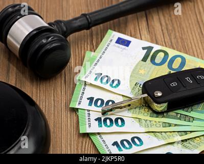 jugde gavel or auction hammer with euro money banknotes and car keys on wooden table Stock Photo