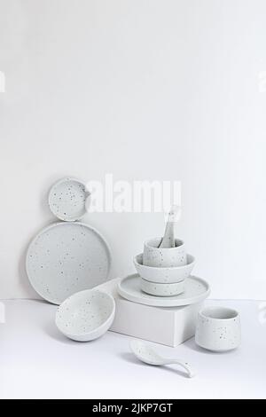 A vertical composition of crockery against white background Stock Photo