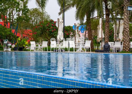 Infinity pool and lounge chairs in a luxury hotel Stock Photo