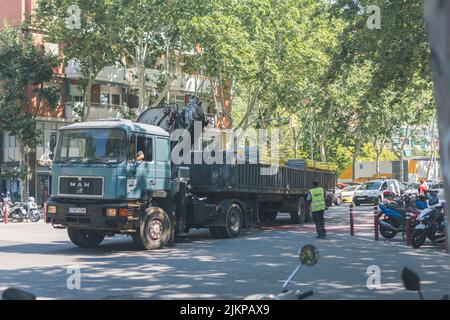 Old and big truck with crane and trailer in the city Stock Photo