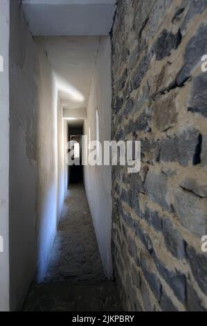 Light at the end of a narrow corridor in a house Stock Photo
