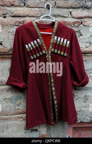Georgian small chokha coat on plastic hanger Stock Photo