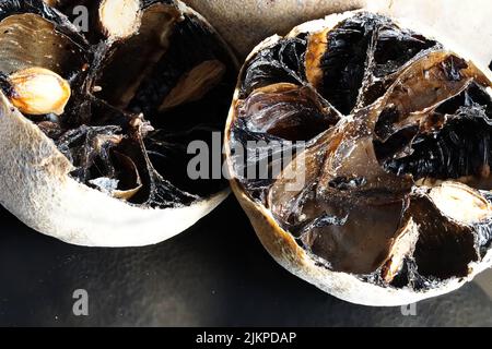 a macro closeup shot of black dried limes for seasoning dishes from Persia, Oman and Arab region - mibu Stock Photo