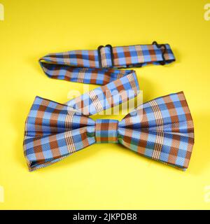 a top view shot of bow tie isolated on yellow background Stock Photo