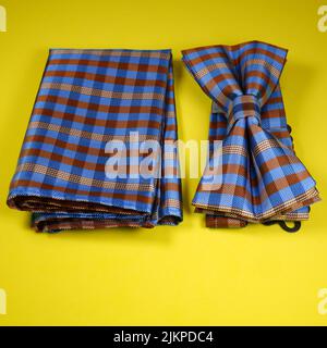 a top view shot of bow tie set isolated on yellow color background Stock Photo