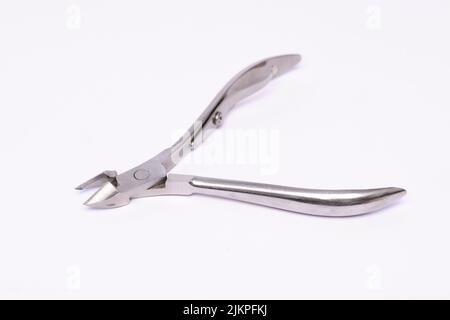 A closeup of a steel stainless nail clipper isolated on white background. Stock Photo
