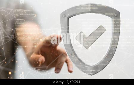 A person's hand touching a grey security icon. information security concept Stock Photo