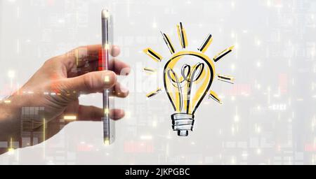 A person's hand holding a phone against a glowing light bulb icon Stock Photo