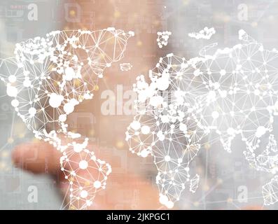 An illustrated world map graphic with the blurred hand of a person showing it from the background Stock Photo