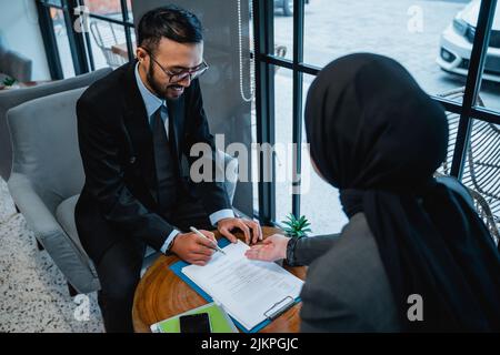 businessman signing an agreement letter during meeting Stock Photo