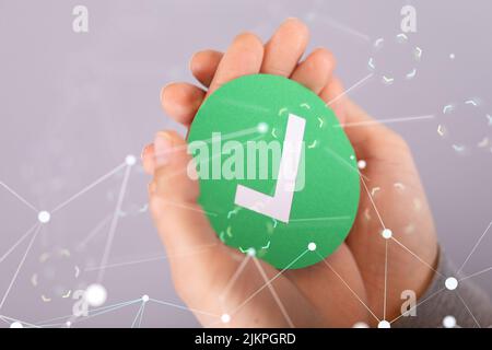 Hands carrying a green thing with a right sign in the white concept of cybersecurity of digital network systems with computer security Stock Photo