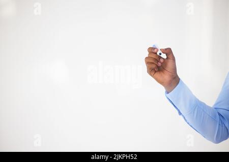 How you use an idea determines its value. an unrecognisable businessman making notes on a glass screen in an office. Stock Photo