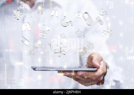 A 3D rendering of User Interface medical icons over a hand holding a phone- medical network concept Stock Photo