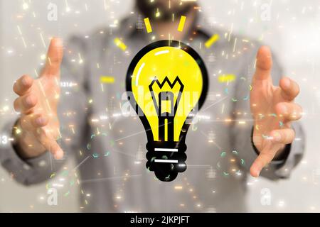 A 3D render of a yellow light bulb in male hands with a blurry background,concept of new ideas Stock Photo
