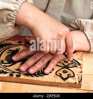 Wooden stamps for medieval ink printing on fabric and vintage clothing. Reconstruction of the events of the Middle Ages in Europe. Stock Photo