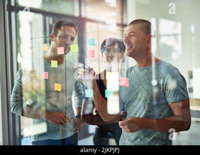 Business people meeting at office and manager giving presentation and writing creative ideas on sticky notes. Team leader discussing and brainstorming Stock Photo
