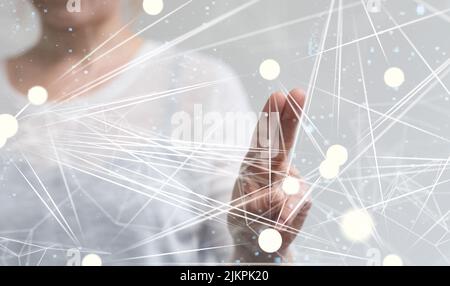 A 3D rendering of a man pointing at hovering sphere network structures Stock Photo