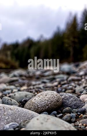A vertical shot of rocks in a forest on a blurred background Stock Photo