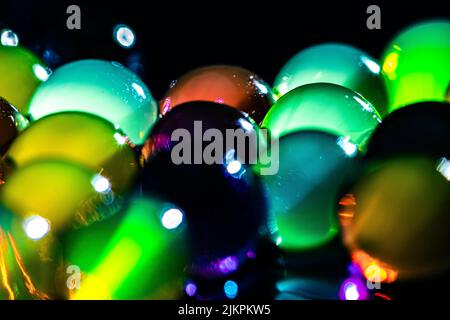 Vibrant water beads in the dark Stock Photo