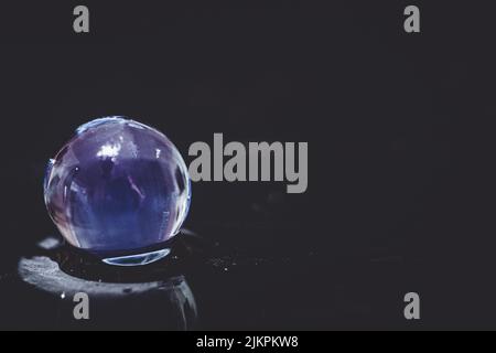 A water bead on a blurred background Stock Photo
