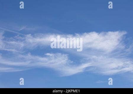 Blue sky with white little cirrus clouds. Stock Photo