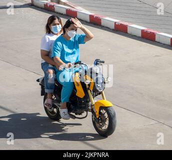 SAMUT PRAKAN, THAILAND, MAY 26 2022, Two women rides on motorcycle at the sunny street. Stock Photo