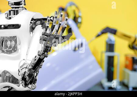 Artificial Intelligence (AI) on blurred industrial robotics working with auto part background, automation work instead on human concept, industry 4.0 Stock Photo