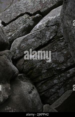 A vertical closeup of dark gray stones. Natural pattern. Stock Photo