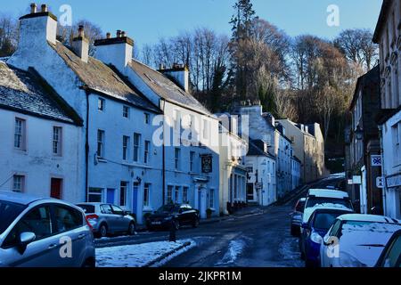 A winter view along High Street in Dunkeld with the Perth Arms Hotel in the centre. Early morning snow covers the streets. Stock Photo