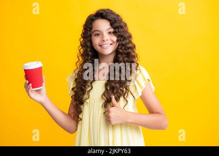 Happy school girl holding coffee cup, learning and education. Coffee break and school recess. Back to school. Teenager student plastic takeaway cup Stock Photo