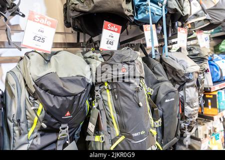 Rucksacks and backpacks on sale prices in a Millets store in Bury, July 2022 summer sale on outdoor clothing and accessories,Lancashire,England,Uk Stock Photo