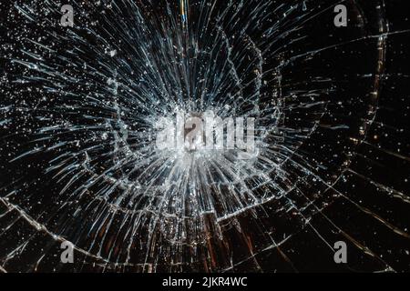 Broken glass texture on black background. Abstract of cracked screen smartphone from shock. Stock Photo