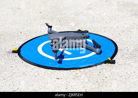 DJI Mavic on its landing pad on a remote sandy beach in Scotland Stock Photo