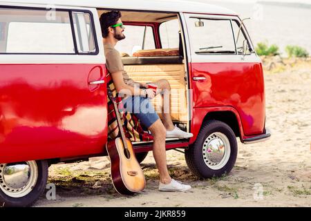 Full size portrait of peaceful positive handsome guy sit van salon dream inspire enjoy spend free time outdoors Stock Photo