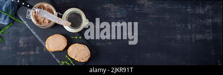 Sandwich with chicken liver pate on dark background. Top view Stock Photo