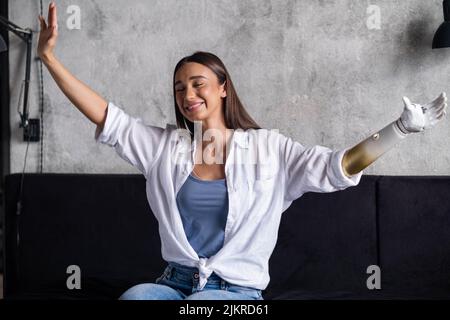 Portrait happy woman with prosthetic arm, girl with disability normal life artificial prosthetic limb, people with special needs  Stock Photo