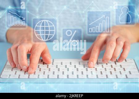 Holographic icons, female hand touching a keyboard . Future technologies and business concept. Stock Photo